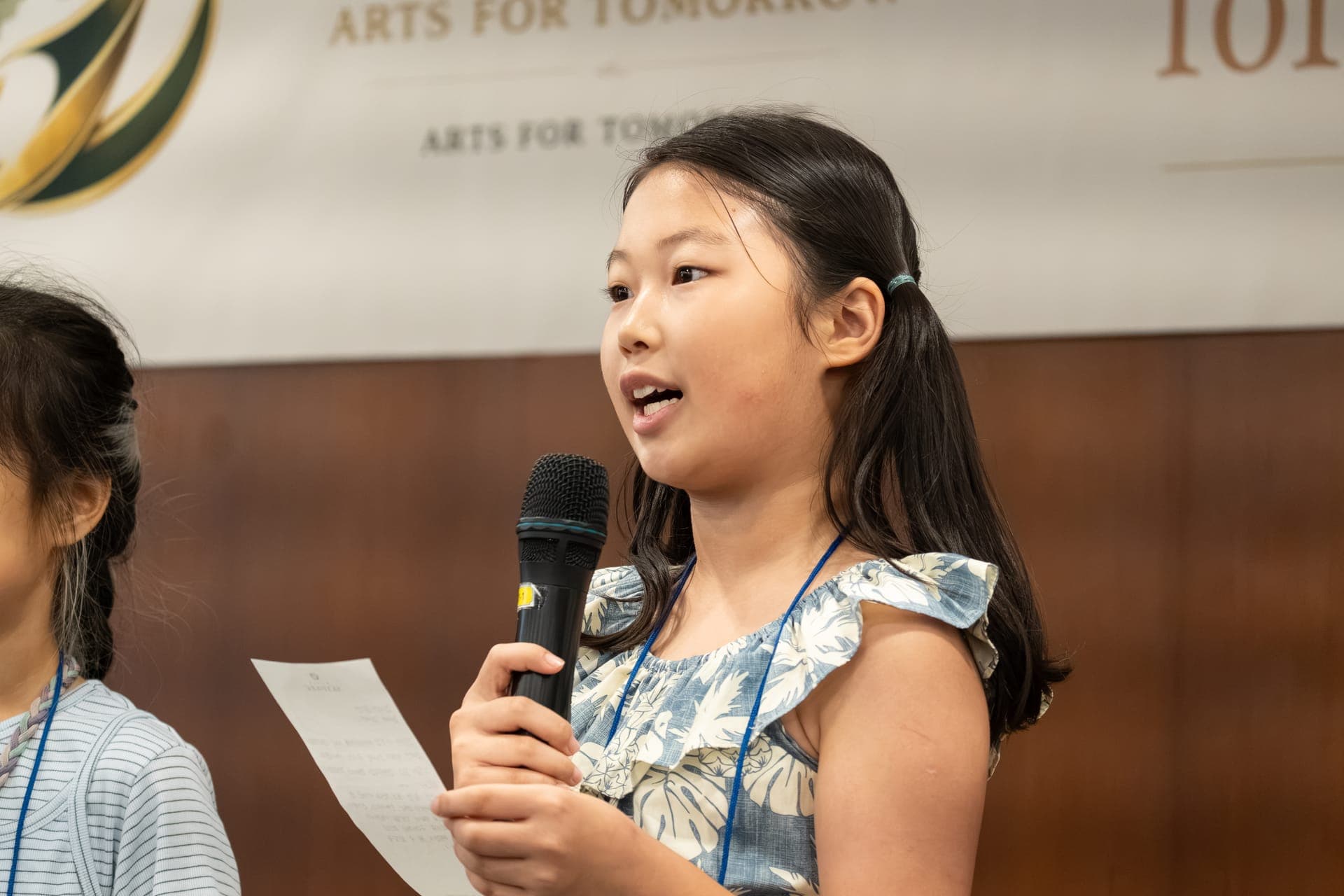A young artist reading her statement aloud