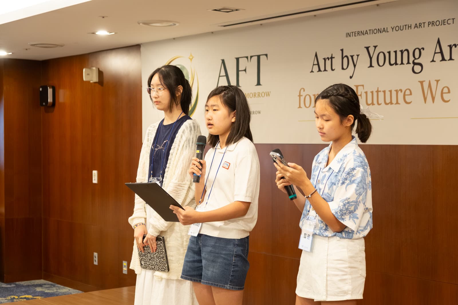 AFT youth presenting on stage